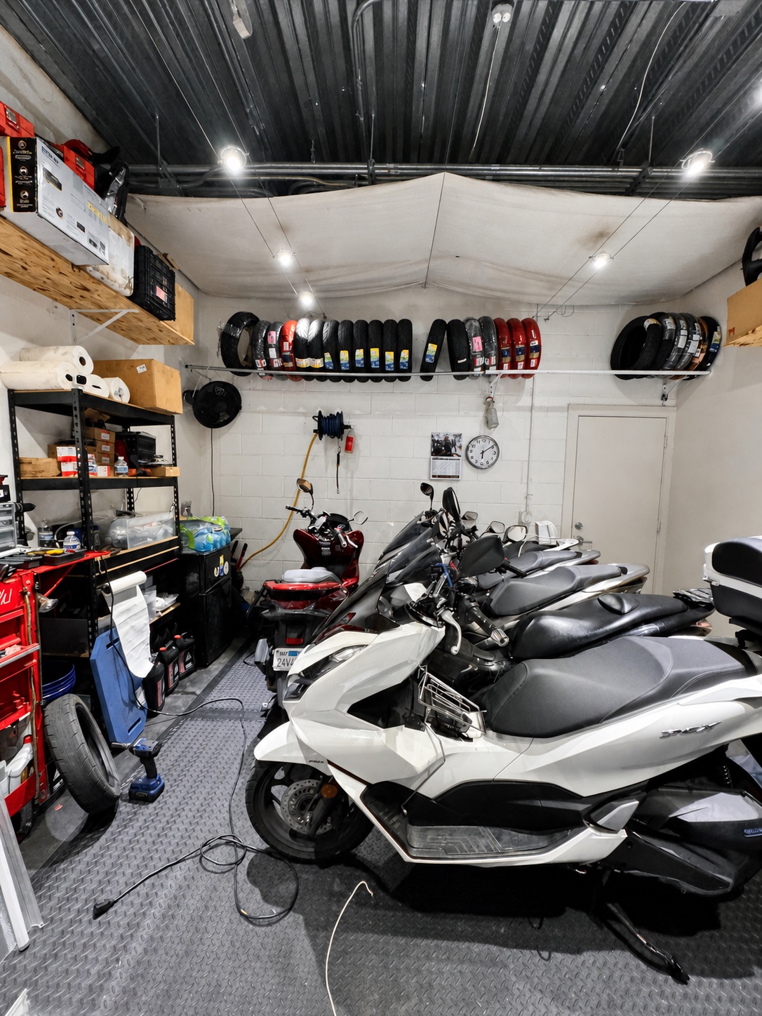 Honda PCX scooters and tires inside the Real Facts workshop