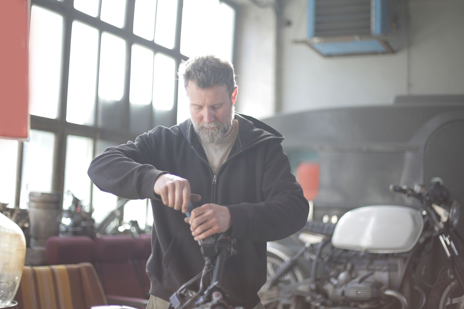 A mechanic working on a motorcycle in a workshop